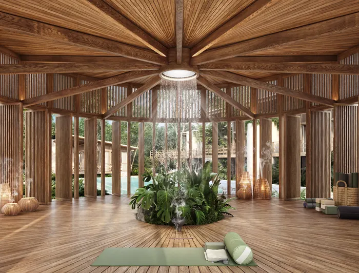 Casa Árbol studio module: a round timber room with a radial ceiling and a yoga mat.